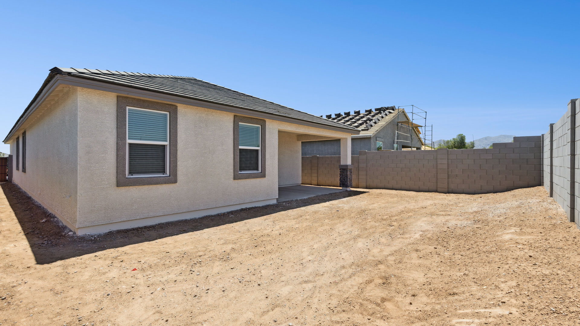 Large fenced-in backyard with a covered patio, perfect for outdoor entertainment.