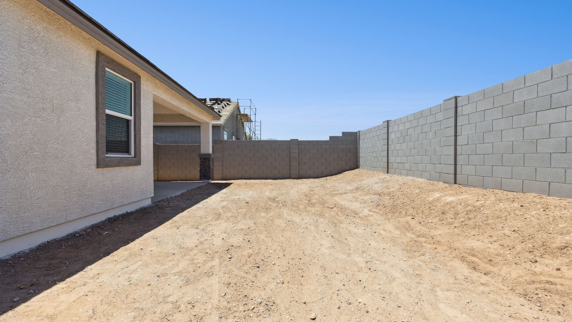 Large fenced-in backyard with a covered patio, perfect for outdoor entertainment.