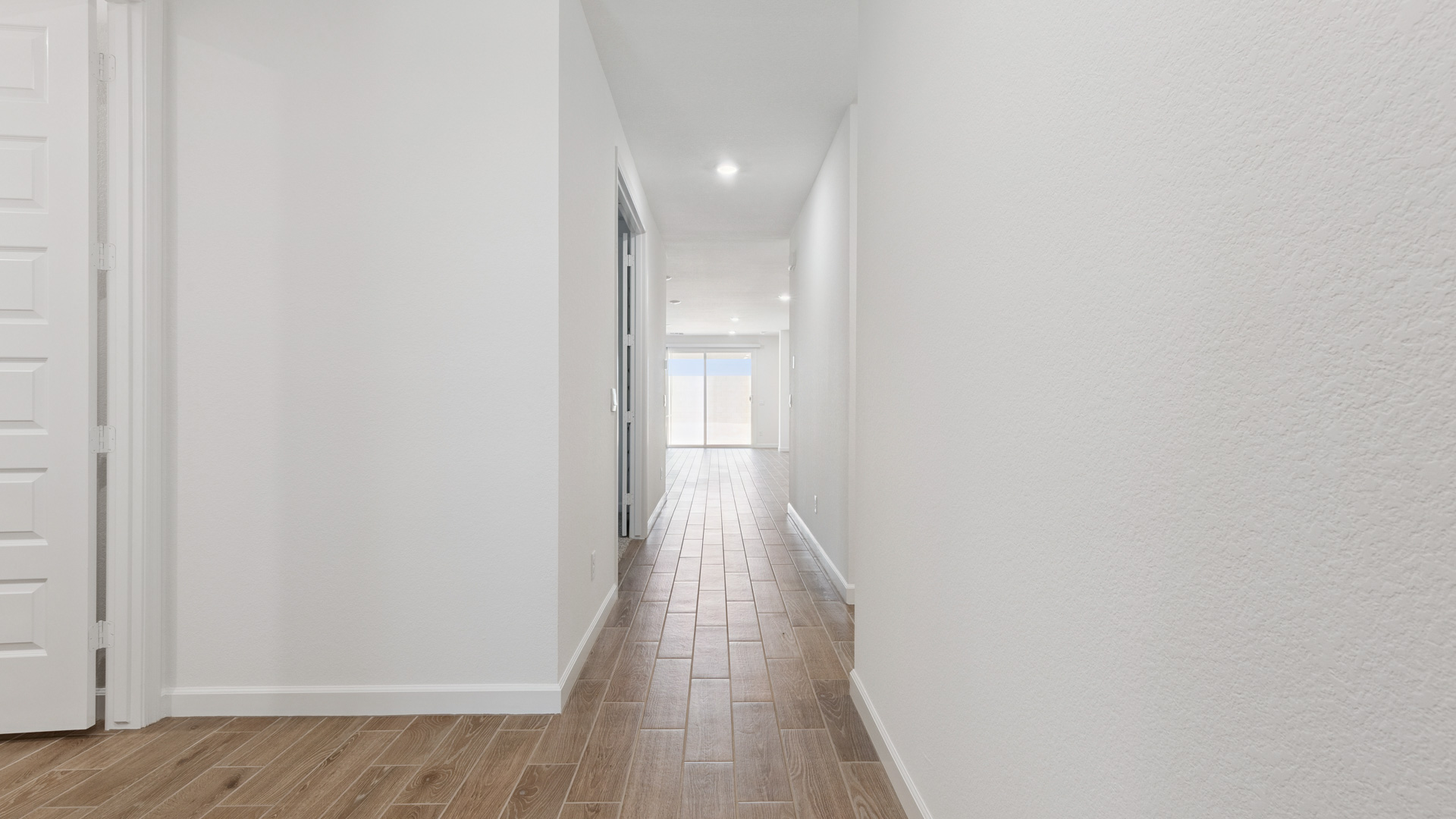 Entry hallway leading to bedrooms in the background.