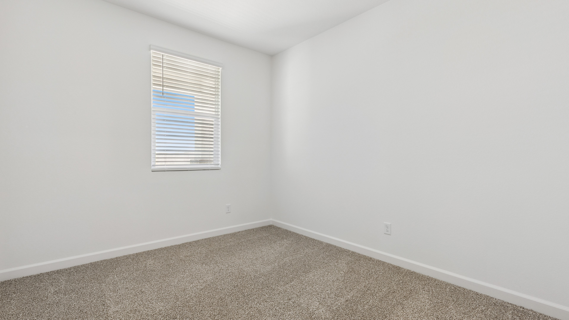 Comfortable guest bedroom featuring neutral-toned walls and a large closet.