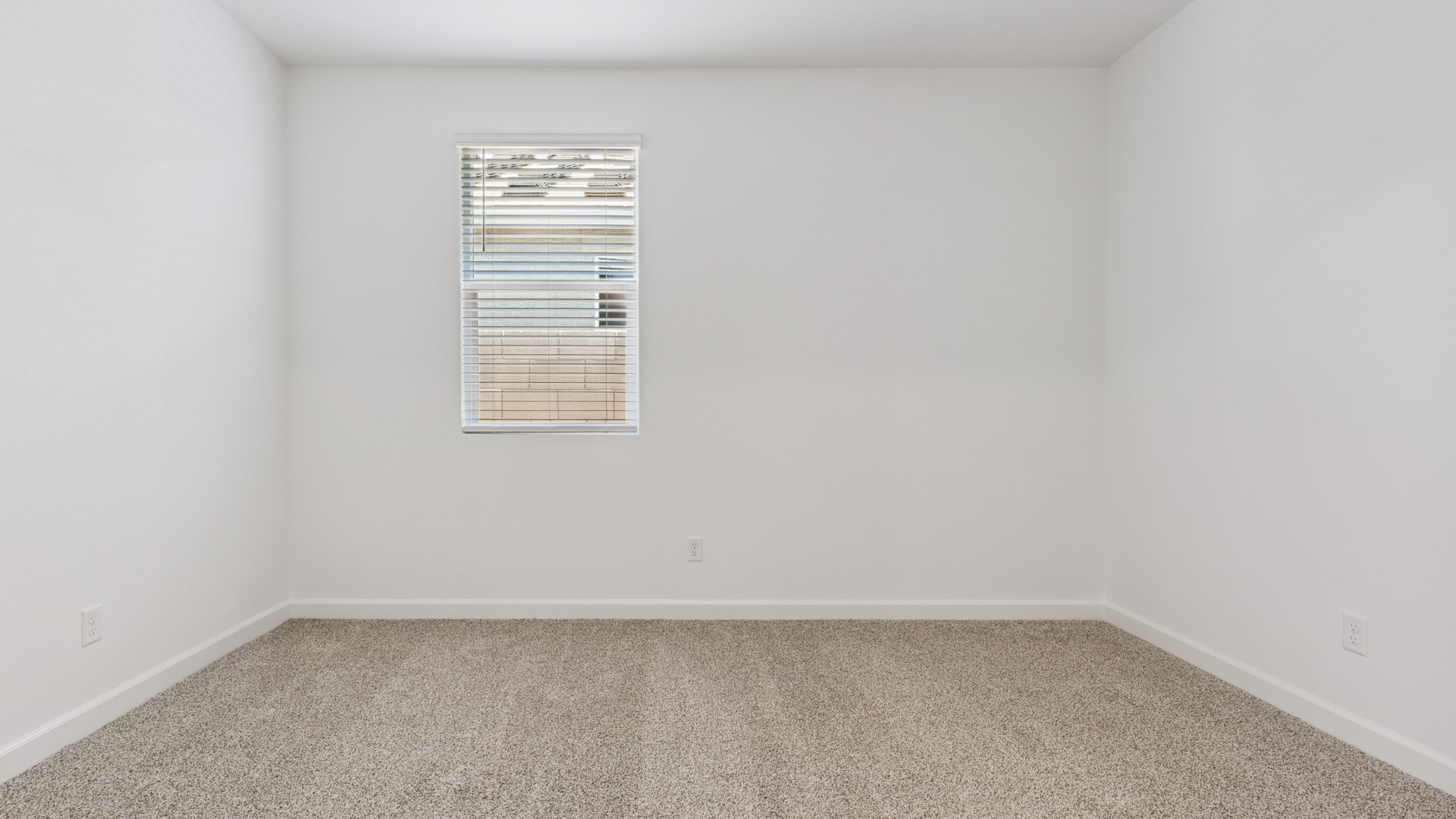 Comfortable guest bedroom featuring neutral-toned walls and a large closet.