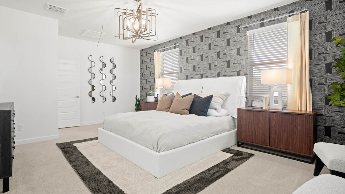 A spacious primary bedroom emphasizing open space and natural lighting.