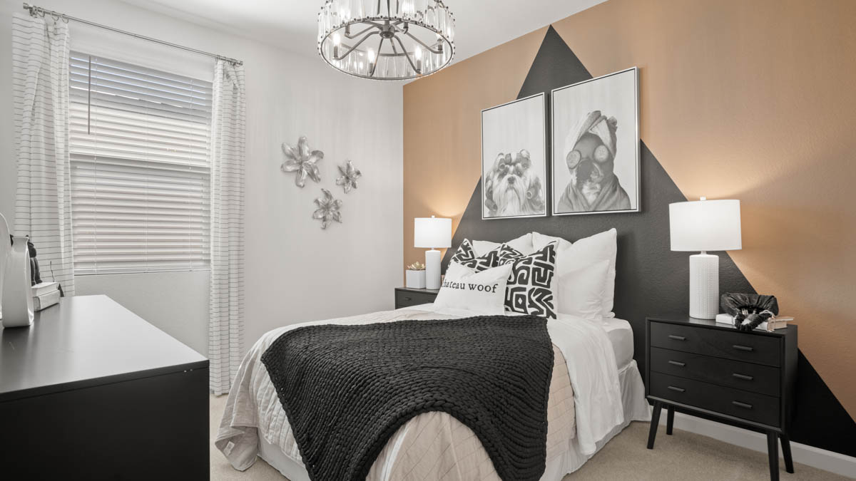 Comfortable guest bedroom featuring neutral-toned walls and a large closet.