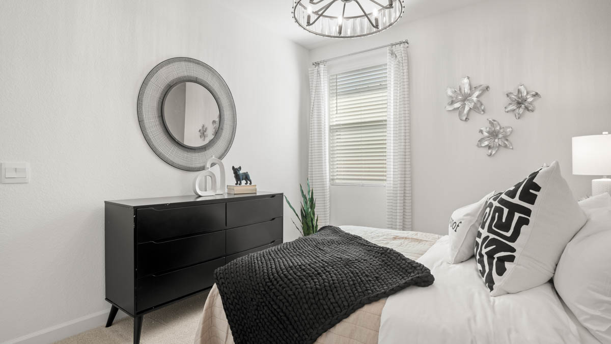 Comfortable guest bedroom featuring neutral-toned walls and a large closet.