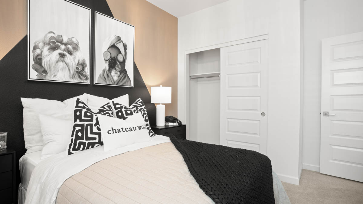 Comfortable guest bedroom featuring neutral-toned walls and a large closet.