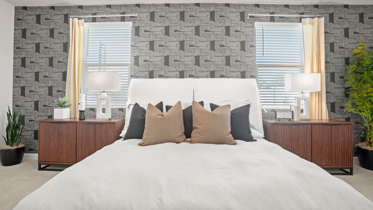 A spacious primary bedroom emphasizing open space and natural lighting.