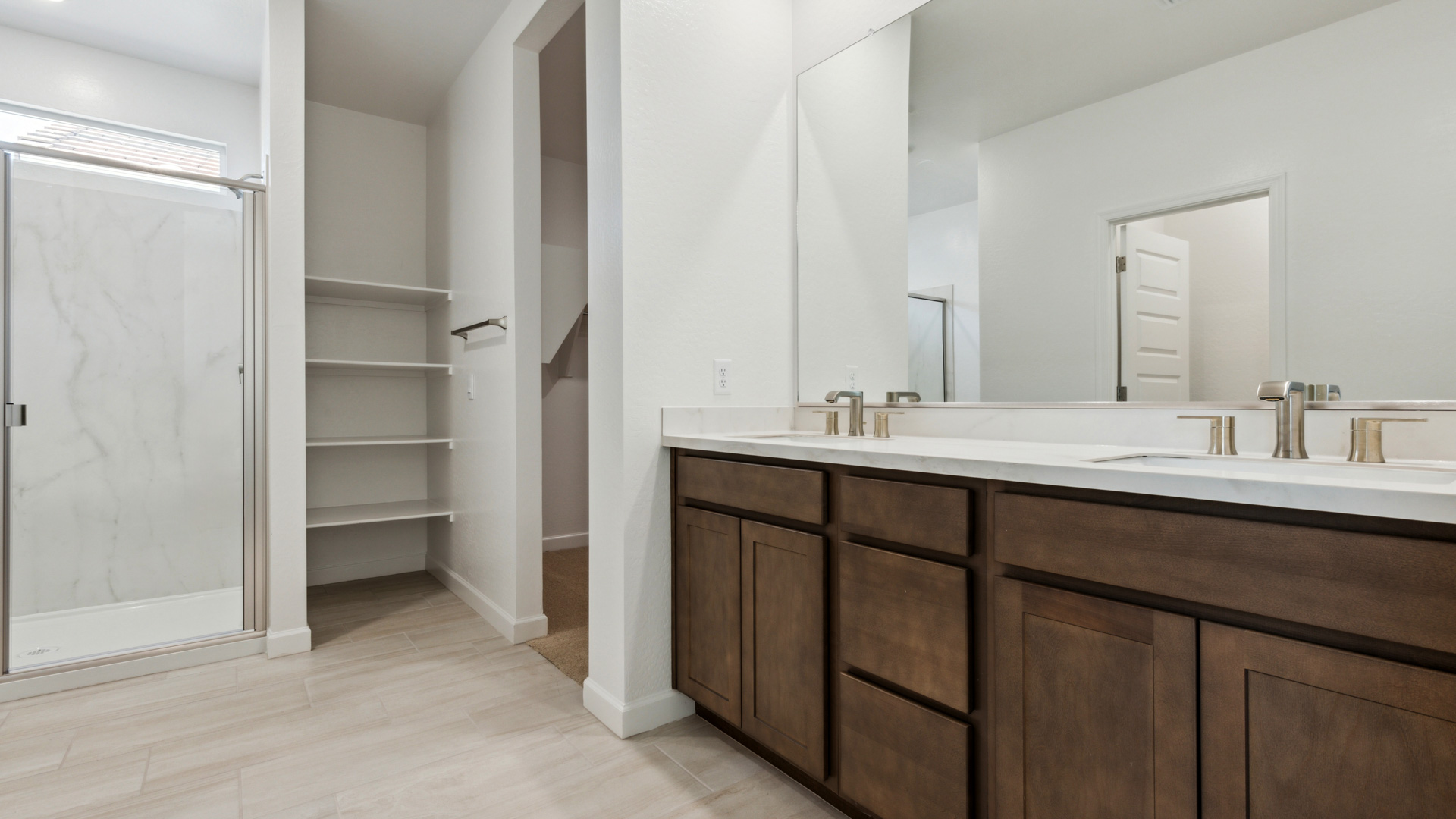 primary bathroom with dual vanities