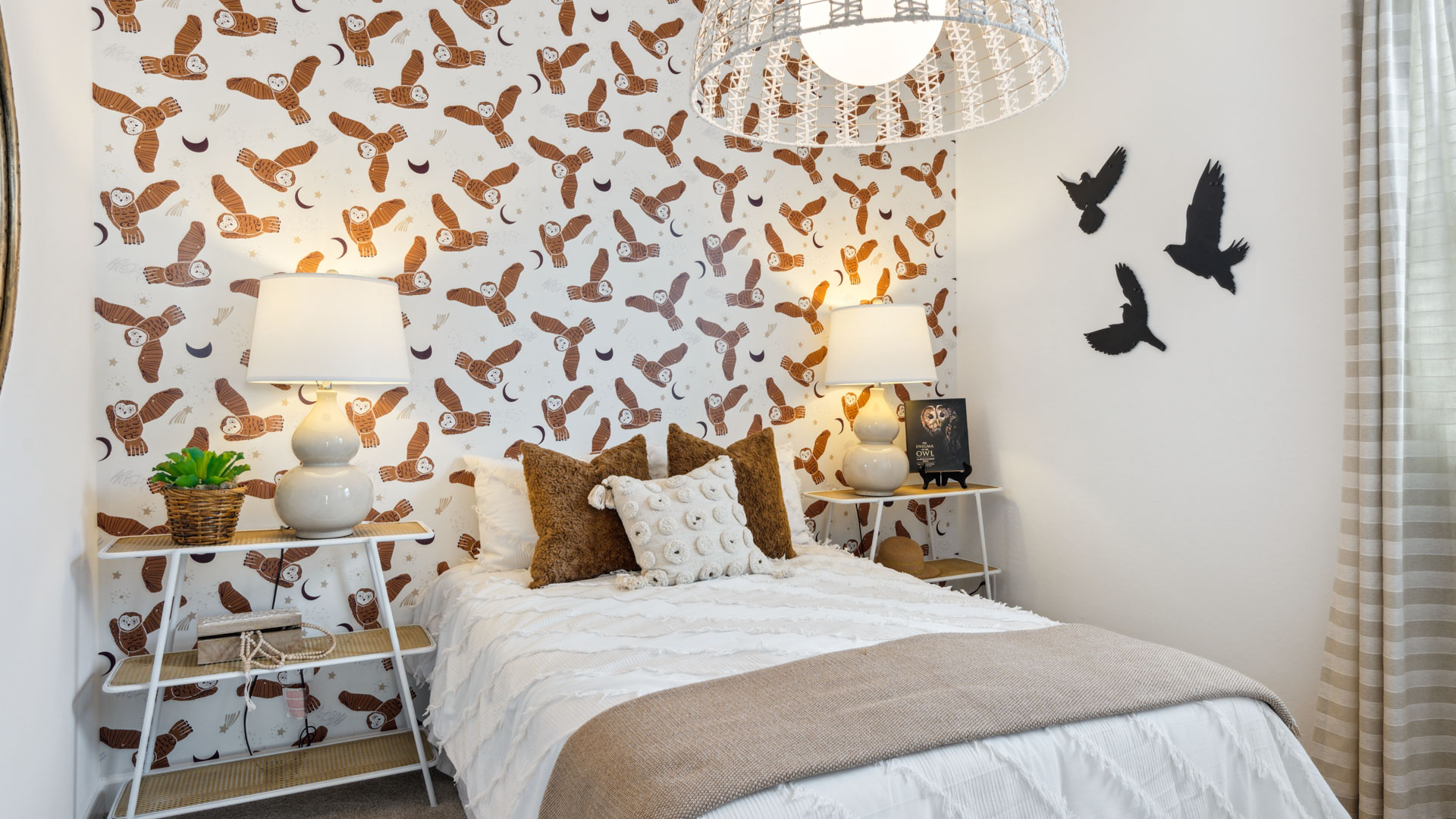 A vibrant kids' bedroom showcasing a neatly made bed, a stylish dresser, and a playful painting that adds charm.
