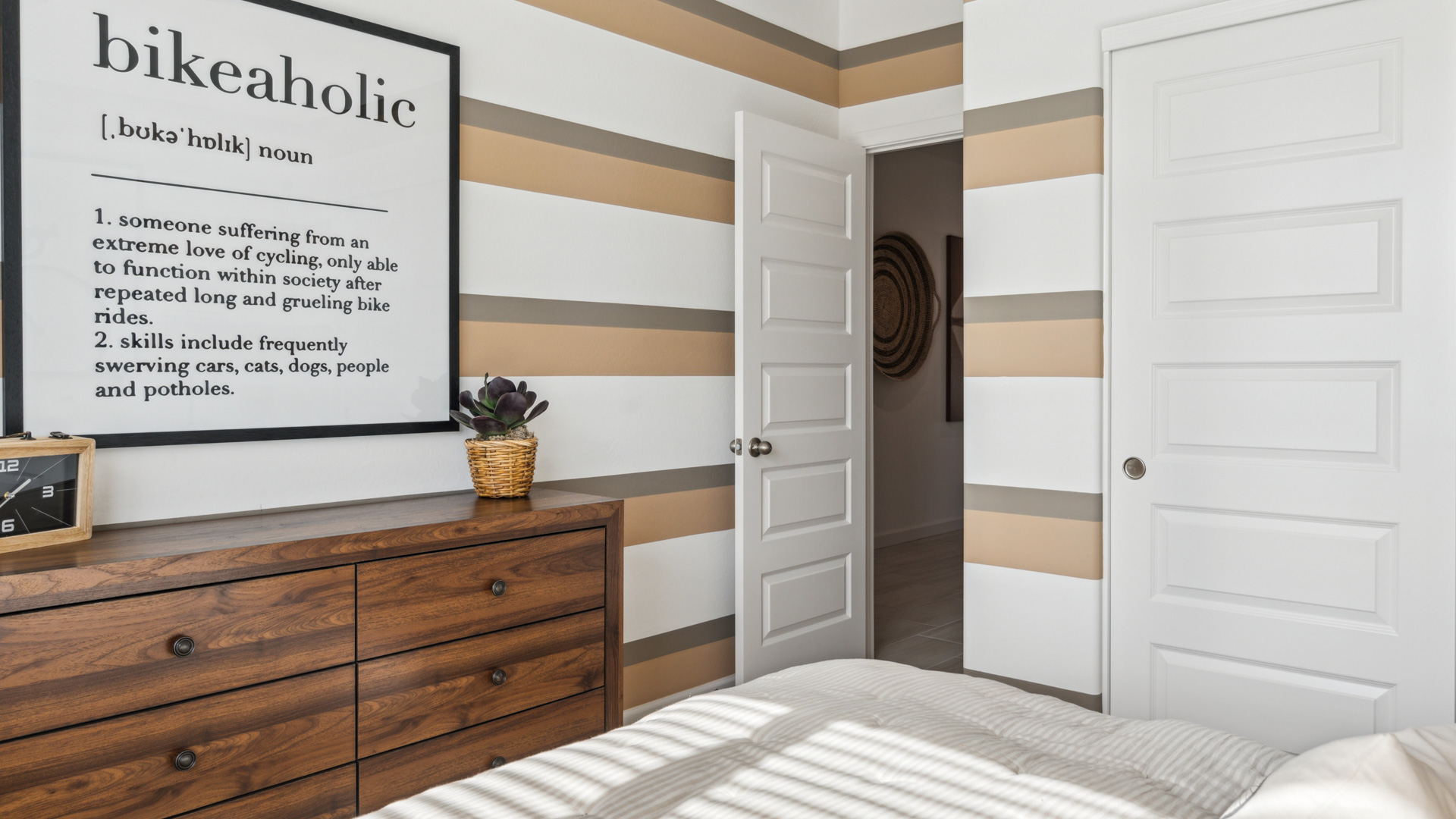 Comfortable guest bedroom featuring neutral-toned walls and a large closet.
