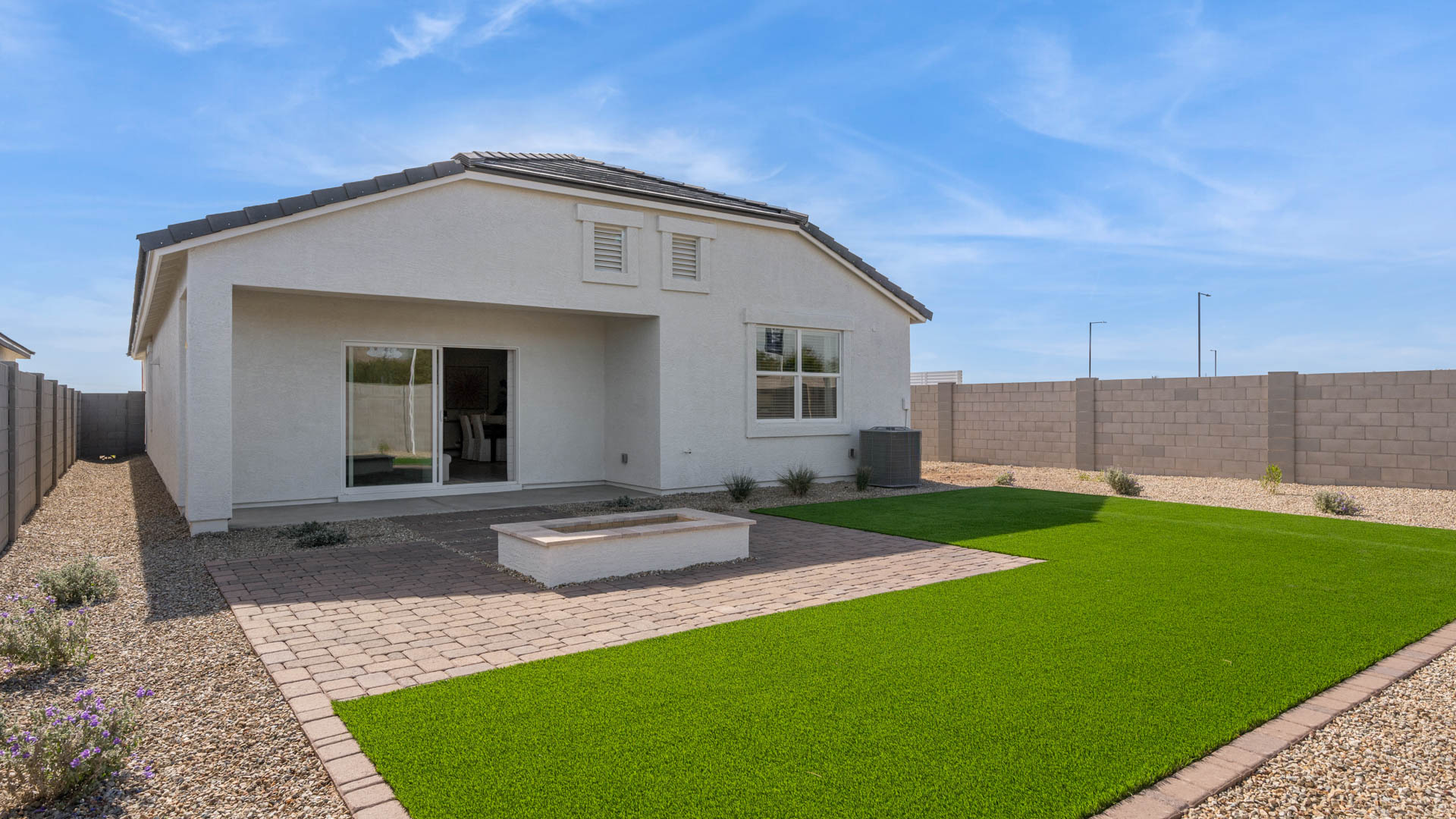 Large fenced-in backyard with a covered patio, perfect for outdoor entertaining.