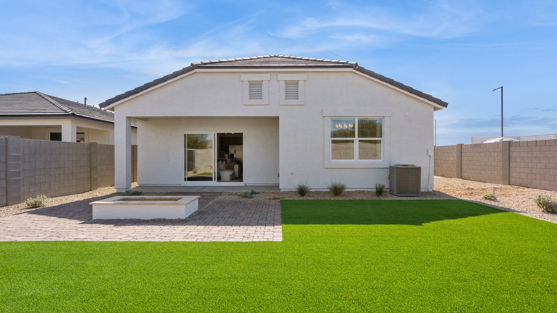 Large fenced-in backyard with a covered patio, perfect for outdoor entertaining.