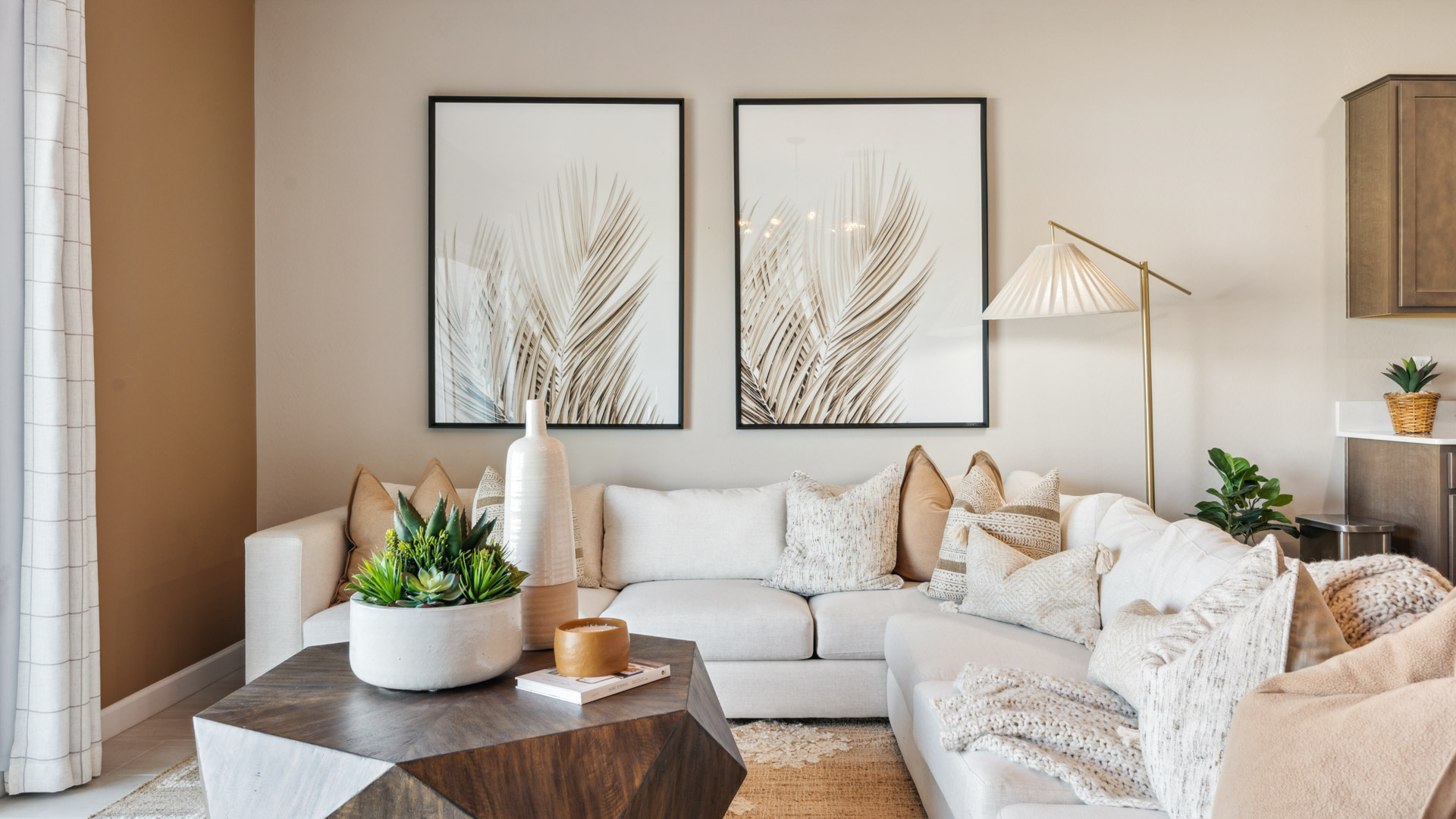 A cozy living room featuring a comfortable couch, a stylish coffee table, and an elegant painting on the wall.