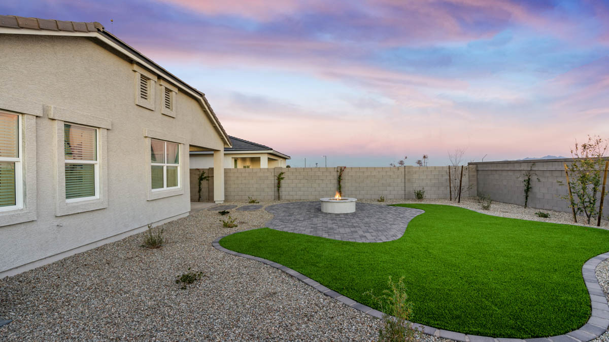 Large fenced-in backyard with a covered patio, perfect for outdoor entertainment.