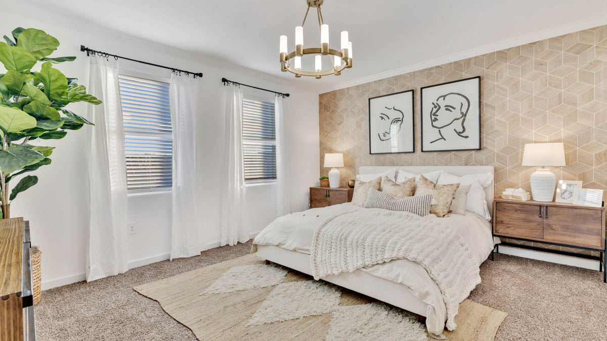 A spacious primary bedroom emphasizing open space and natural lighting.