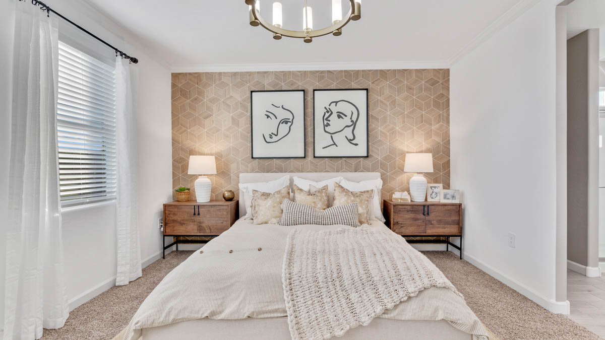 A spacious primary bedroom emphasizing open space and natural lighting.