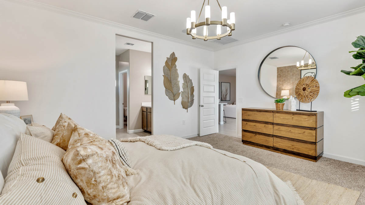 A spacious primary bedroom emphasizing open space and natural lighting.