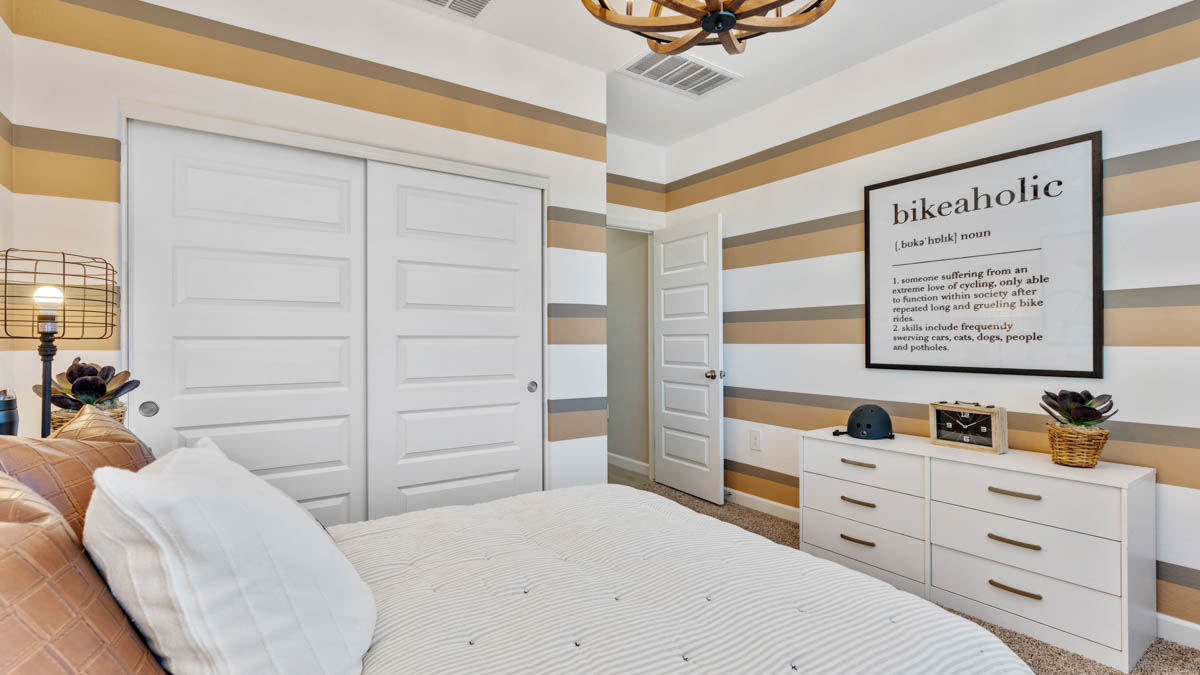 Comfortable guest bedroom featuring neutral-toned walls and a large closet.