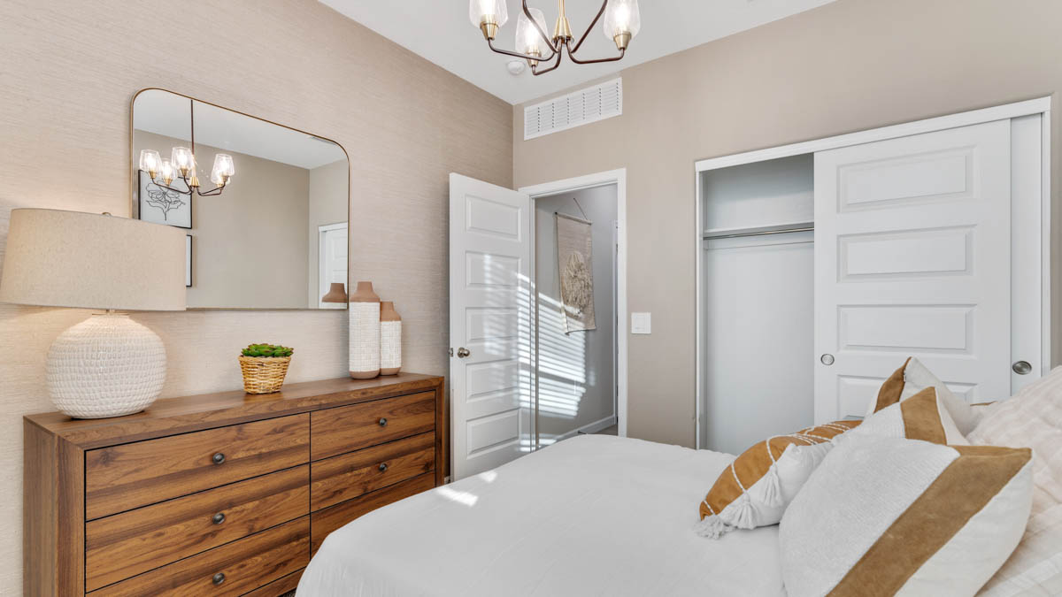 Comfortable guest bedroom featuring neutral-toned walls and a large closet.