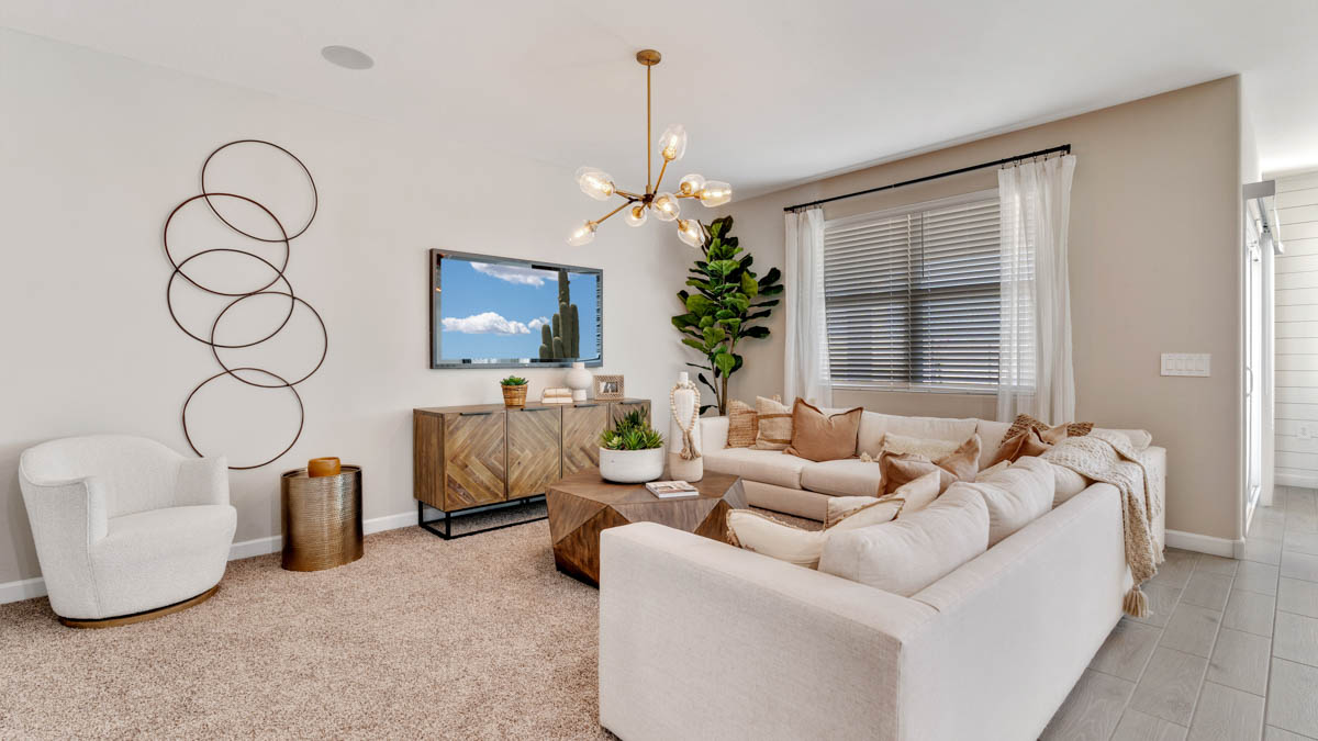 A well-organized living room that includes a kitchen and dining area, creating a warm and welcoming environment for gatherings.