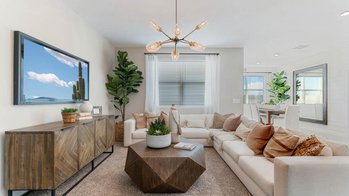 A well-organized living room that includes a kitchen and dining area, creating a warm and welcoming environment for gatherings.