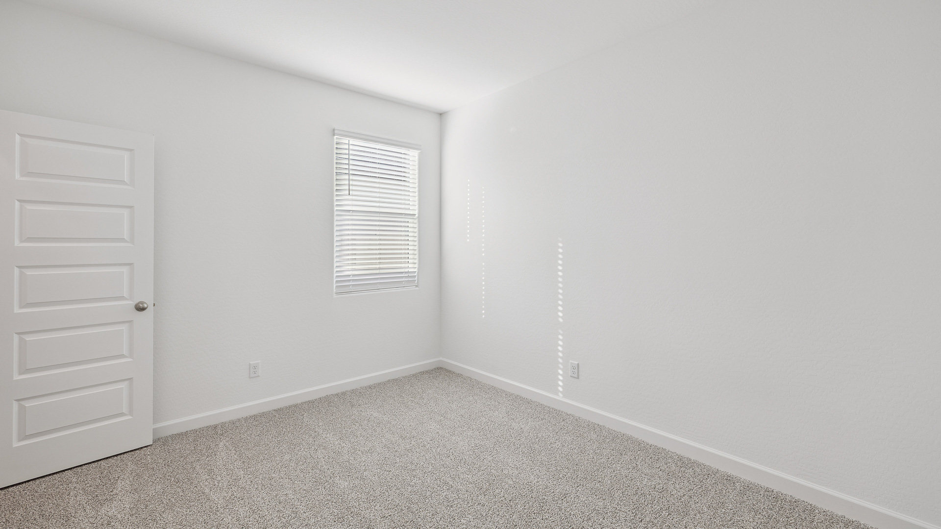 Comfortable guest bedroom featuring neutral-toned walls and a large closet.