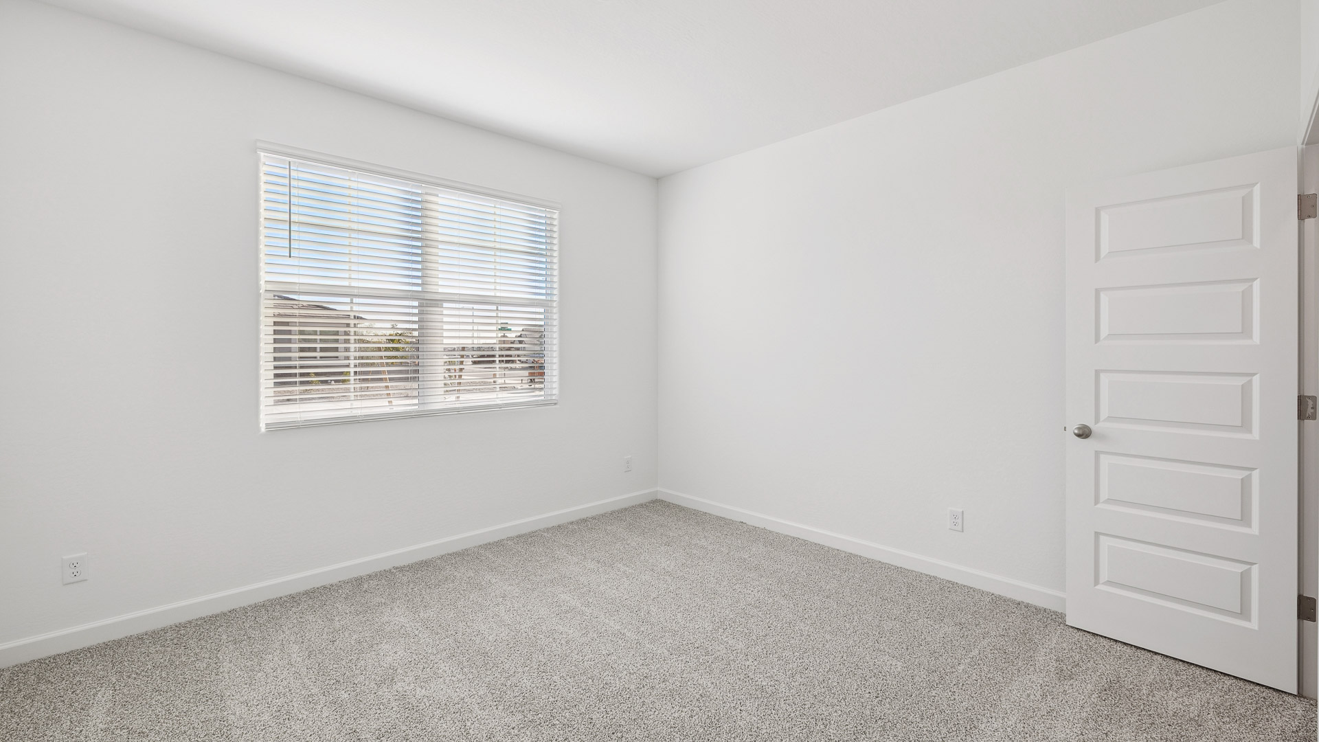 Comfortable guest bedroom featuring neutral-toned walls and a large closet.