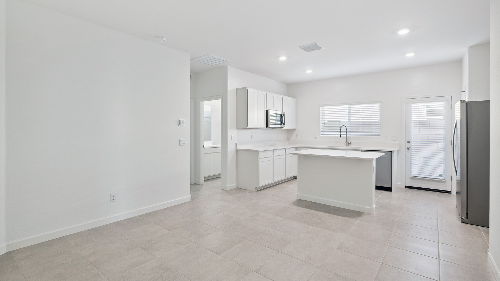 A well-organized living room that includes a kitchen and dining area, creating a warm and welcoming environment for gatherings.