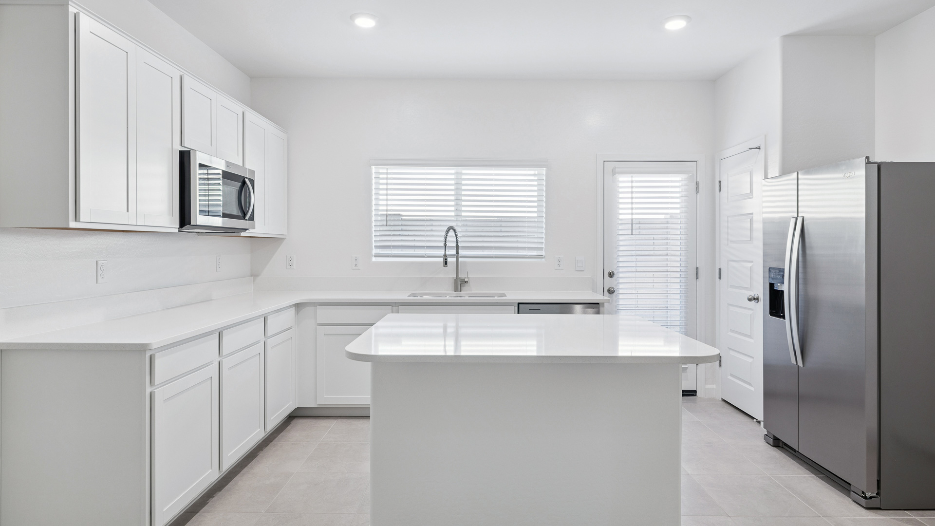A well-organized living room that includes a kitchen and dining area, creating a warm and welcoming environment for gatherings.