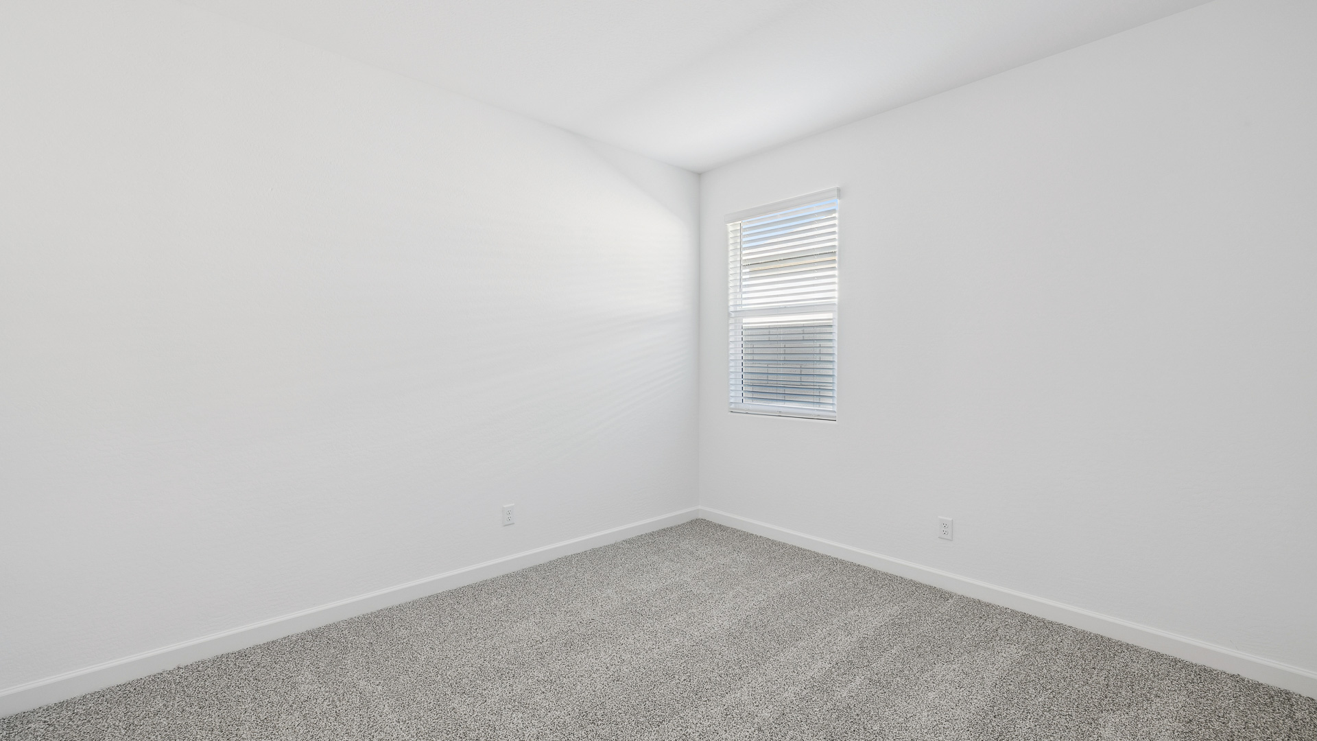 Comfortable guest bedroom featuring neutral-toned walls and a large closet.