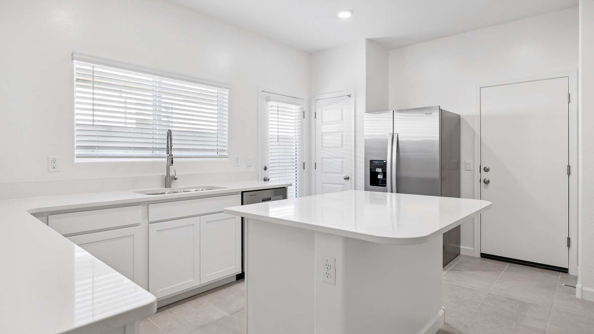 A well-organized living room that includes a kitchen and dining area, creating a warm and welcoming environment for gatherings.