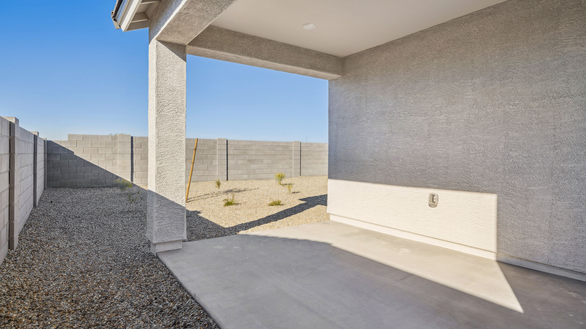 Large fenced-in backyard with a covered patio, perfect for outdoor entertaining.