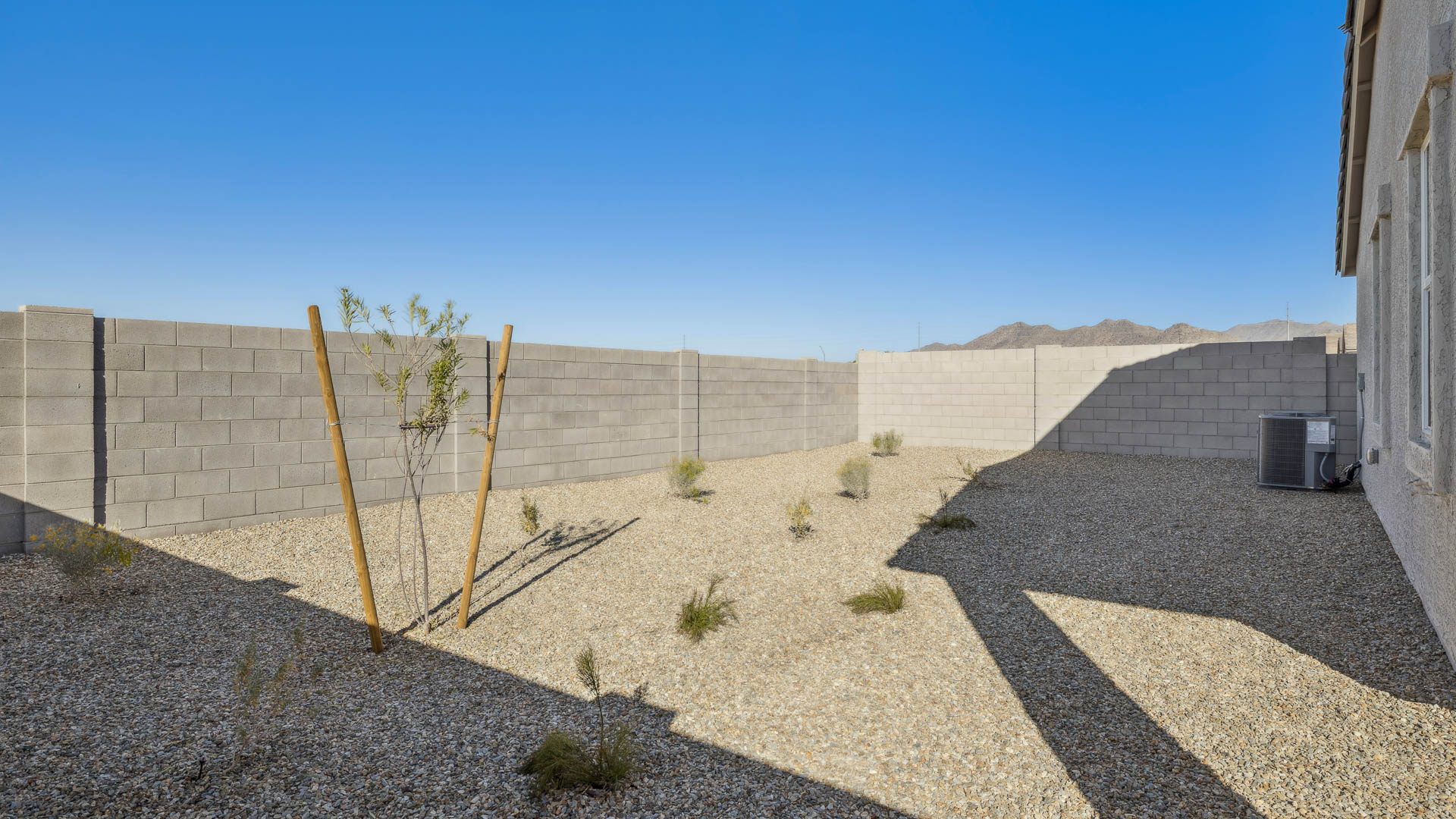 Large fenced-in backyard with a covered patio, perfect for outdoor entertaining.