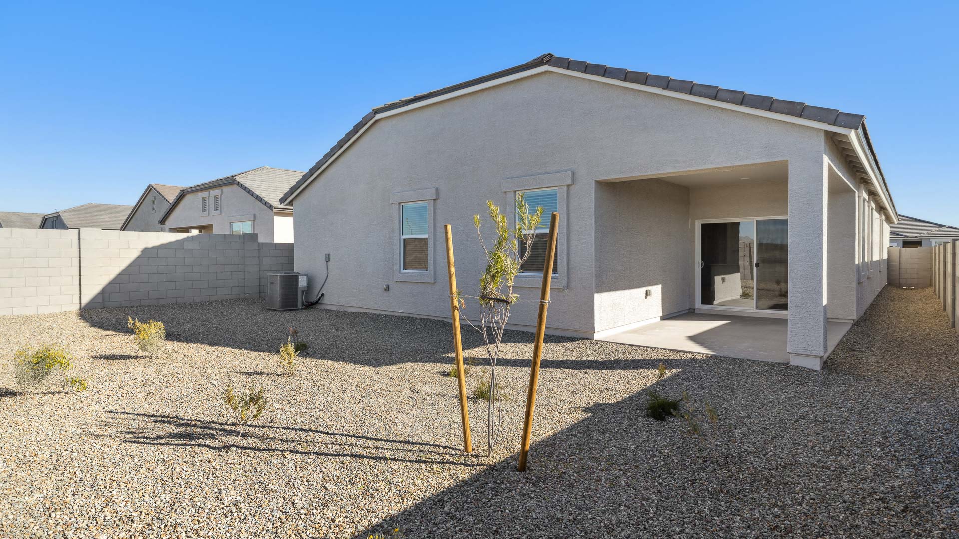 Large fenced-in backyard with a covered patio, perfect for outdoor entertaining.