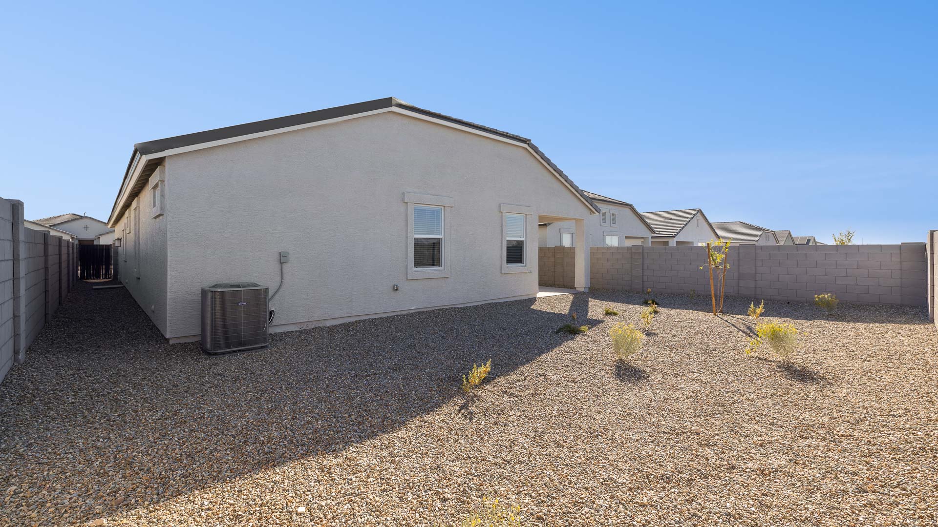 Large fenced-in backyard with a covered patio, perfect for outdoor entertaining.