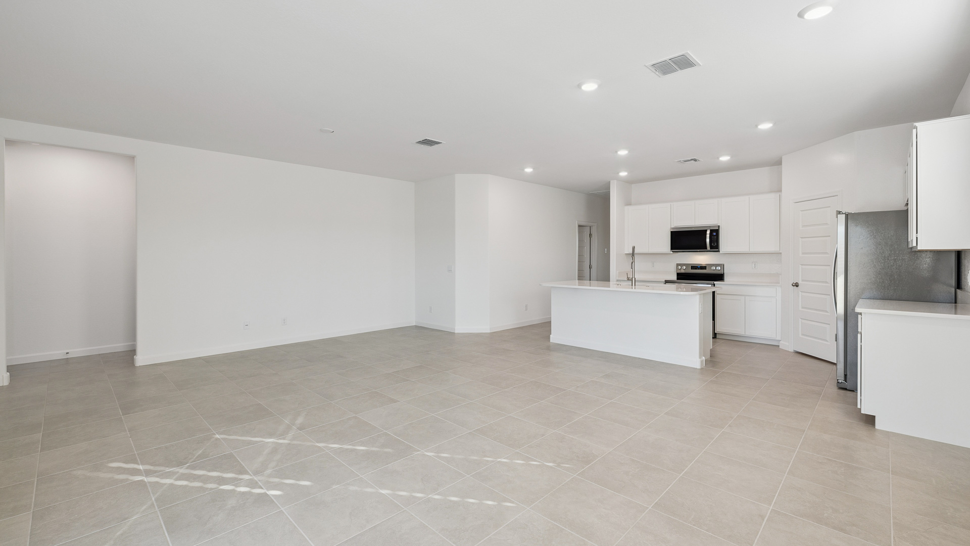A well-organized living room that includes a kitchen and dining area, creating a warm and welcoming environment for gatherings.