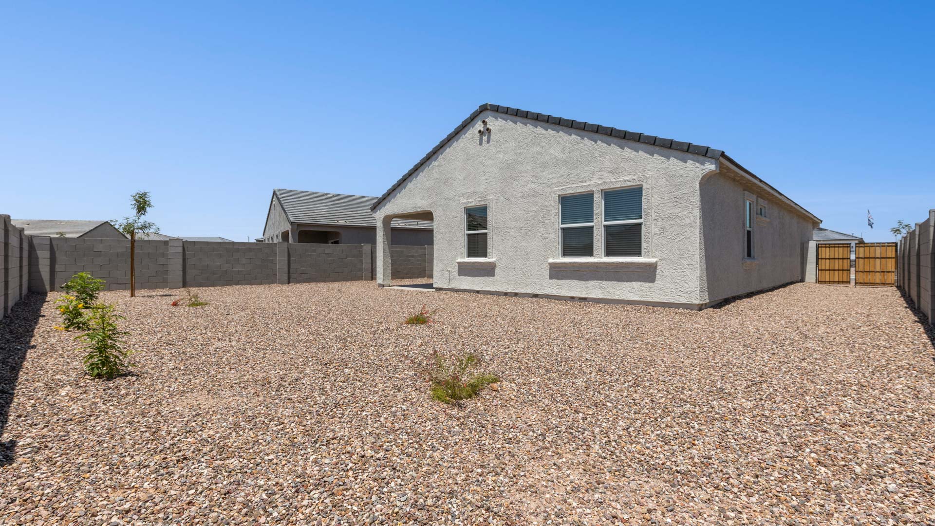 Large fenced-in backyard with a covered patio, perfect for outdoor entertaining.