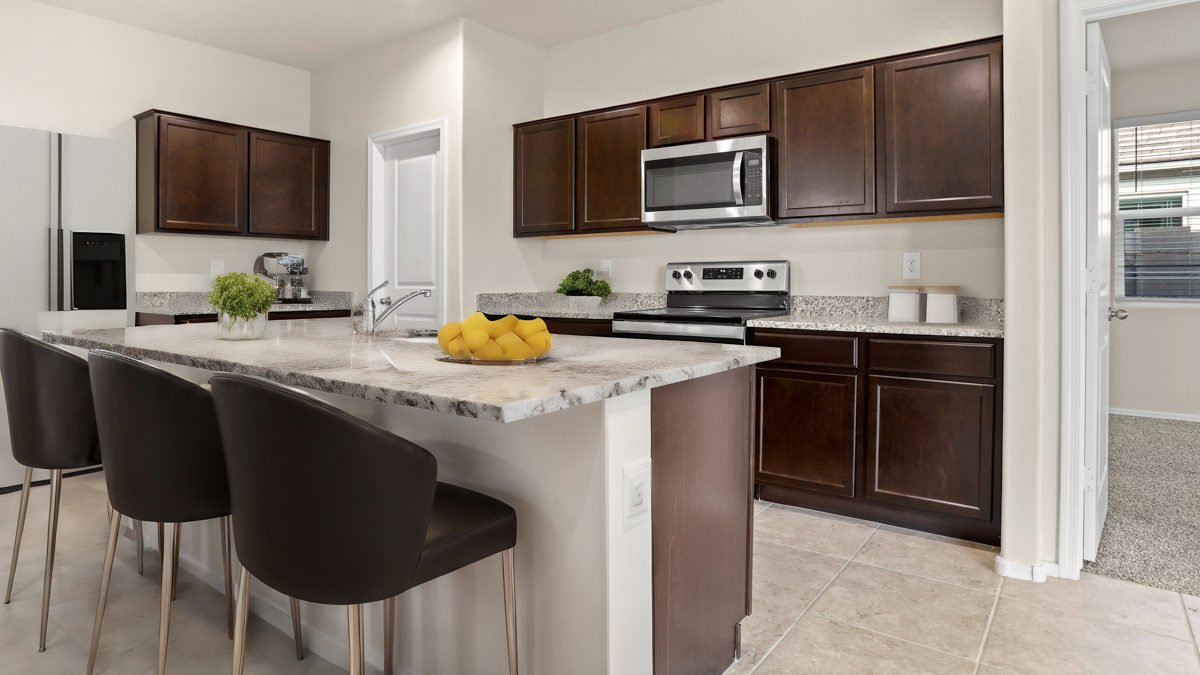 Staged spacious kitchen with island.