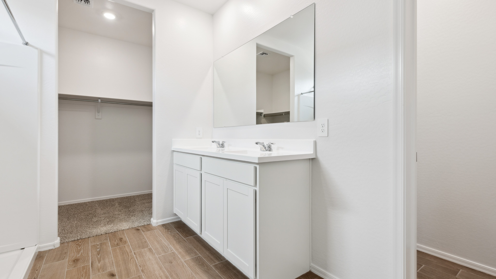 primary bathroom with dual vanities