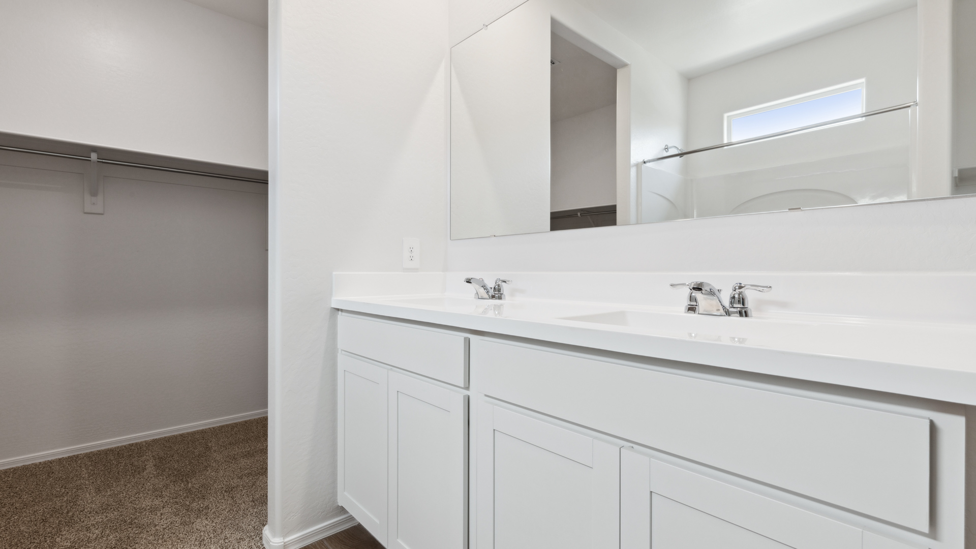 primary bathroom with dual vanities