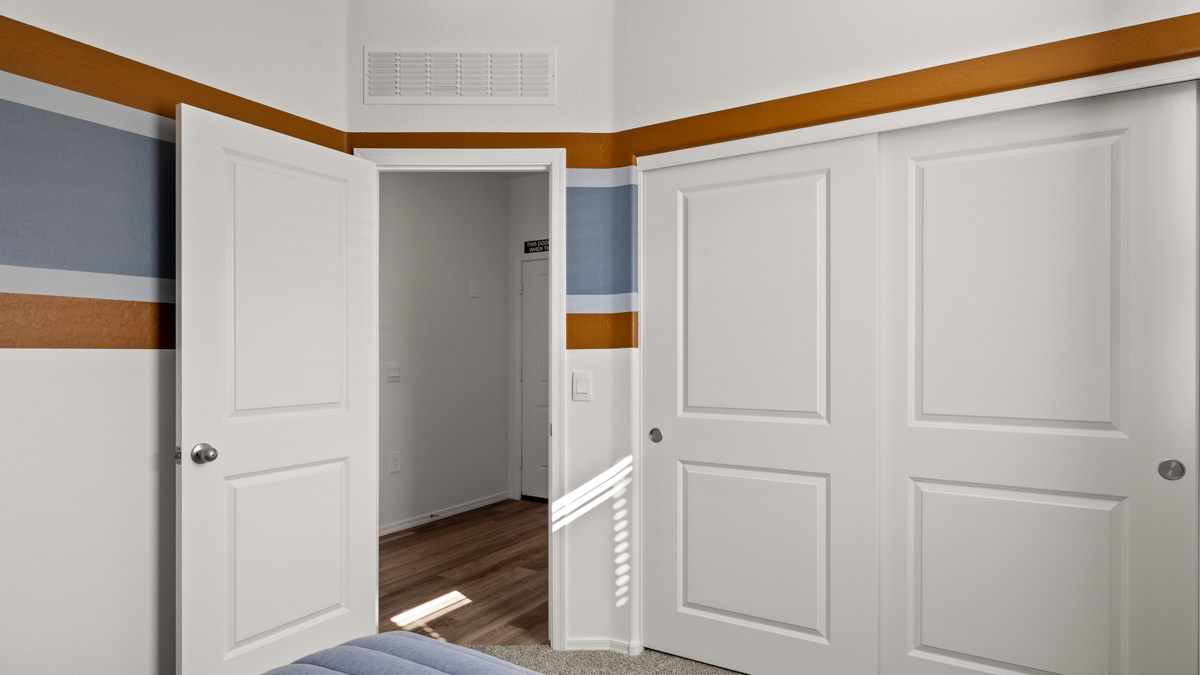 Vibrant kid's room with a large closet.