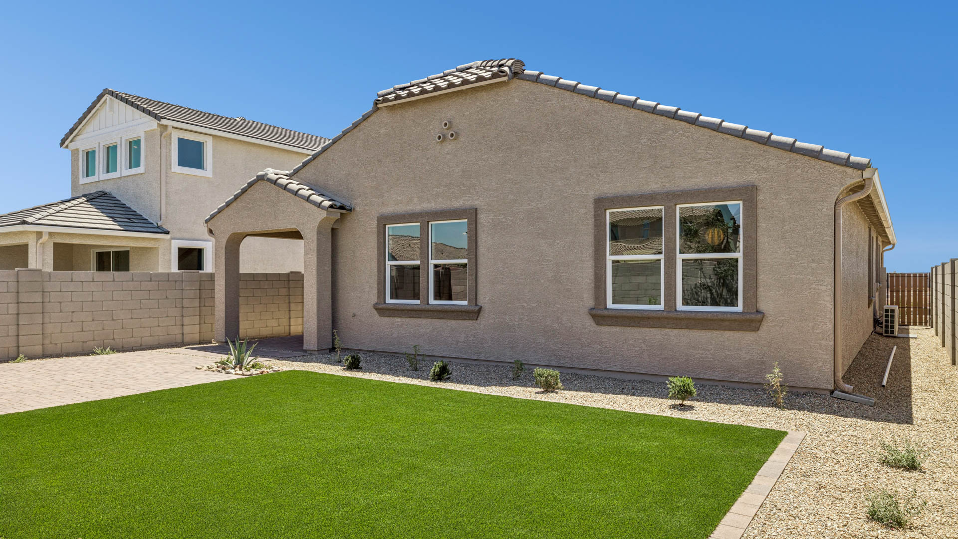 Back of home with covered patio.