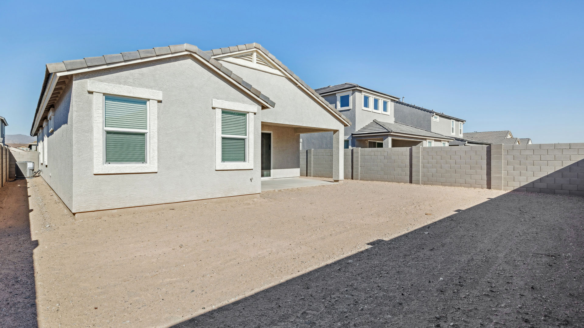 Large fenced-in backyard with a covered patio, perfect for outdoor entertaining.
