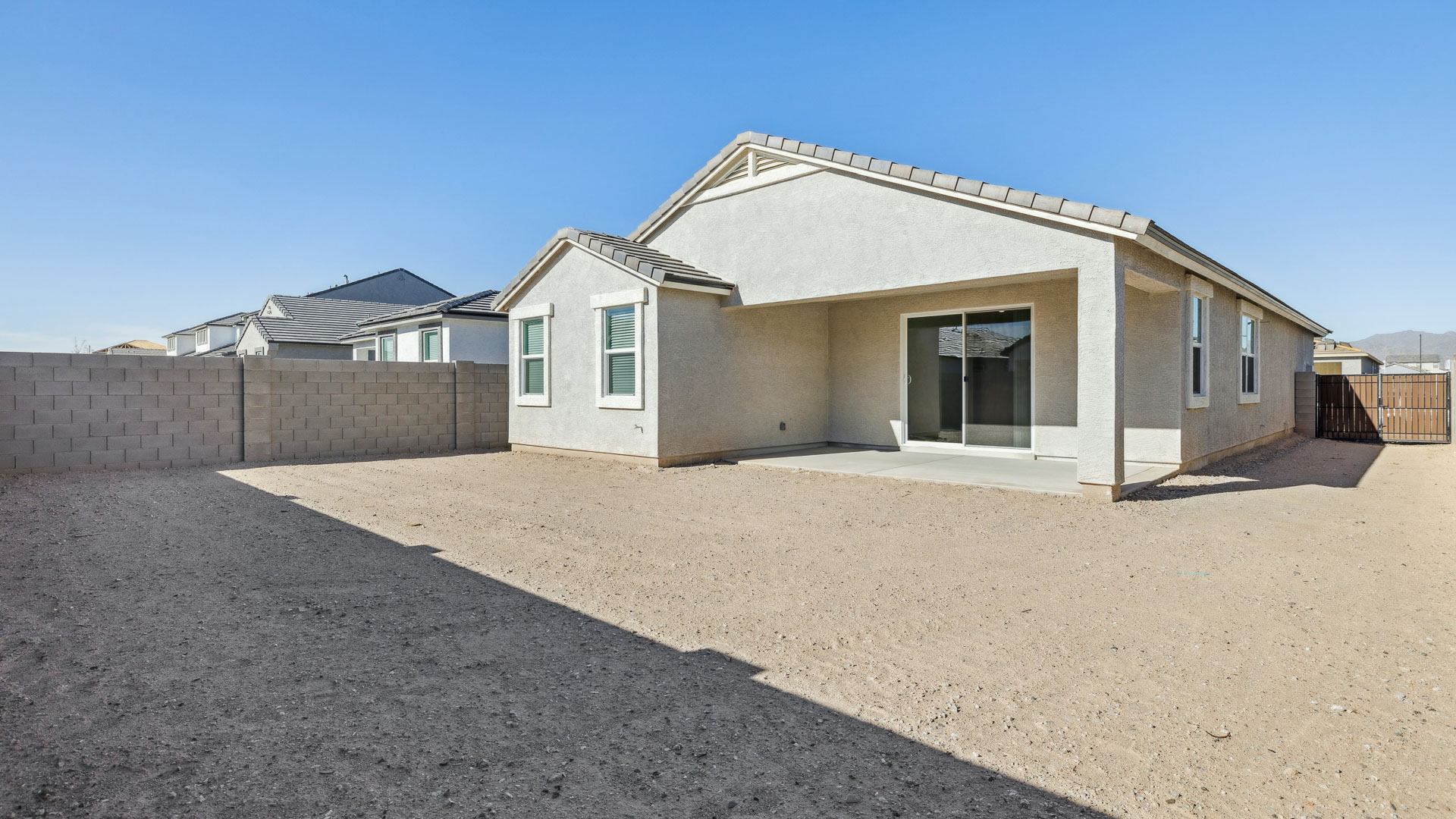 Large fenced-in backyard with a covered patio, perfect for outdoor entertaining.