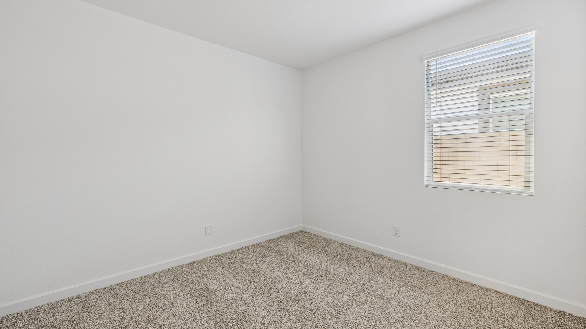 Comfortable guest bedroom featuring neutral-toned walls and a large closet.