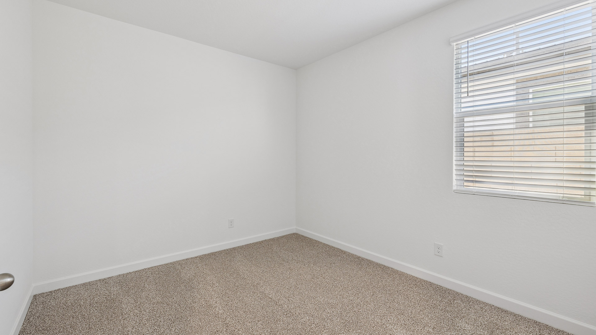 Comfortable guest bedroom featuring neutral-toned walls and a large closet.