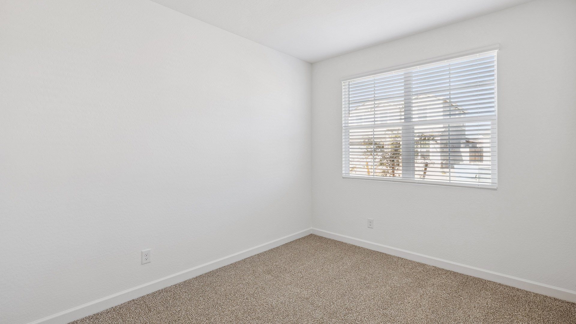 Comfortable guest bedroom featuring neutral-toned walls and a large closet.
