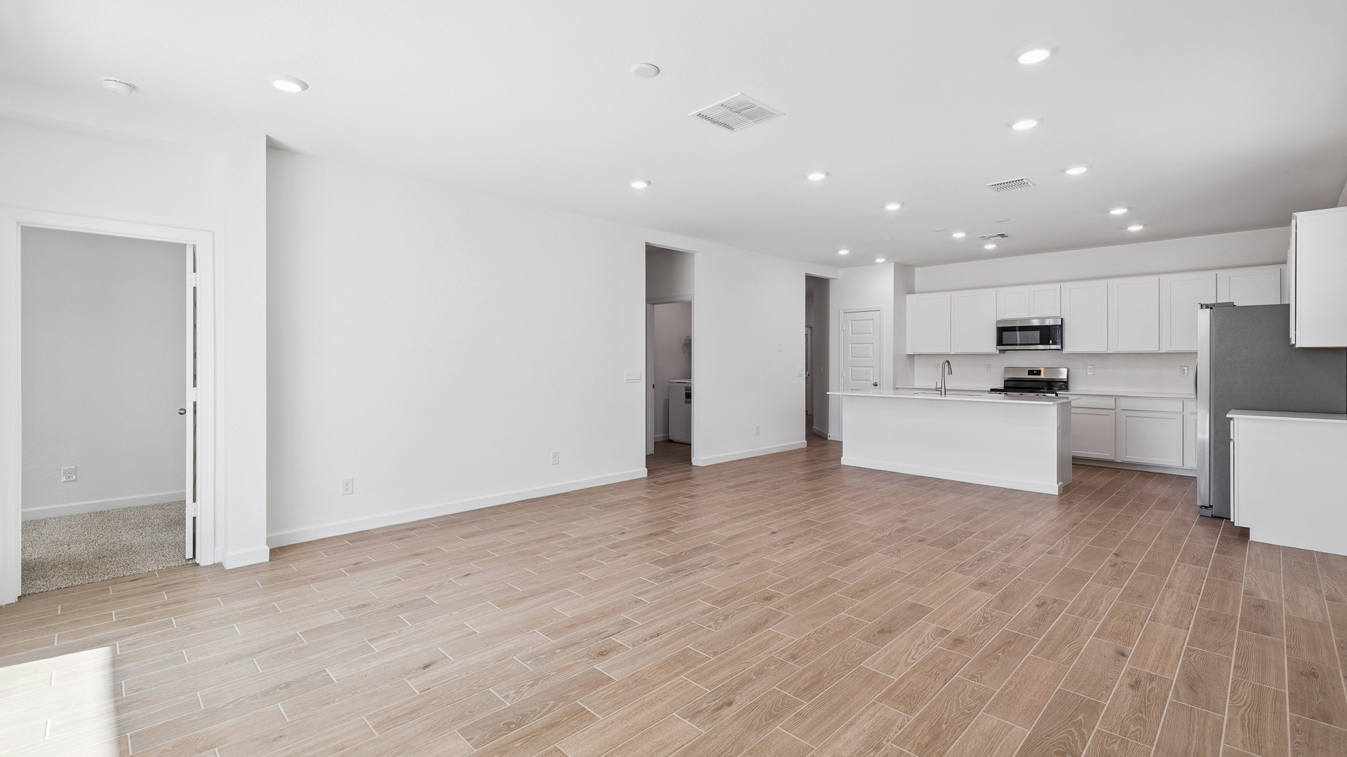 A well-organized living room that includes a kitchen and dining area, creating a warm and welcoming environment for gatherings.