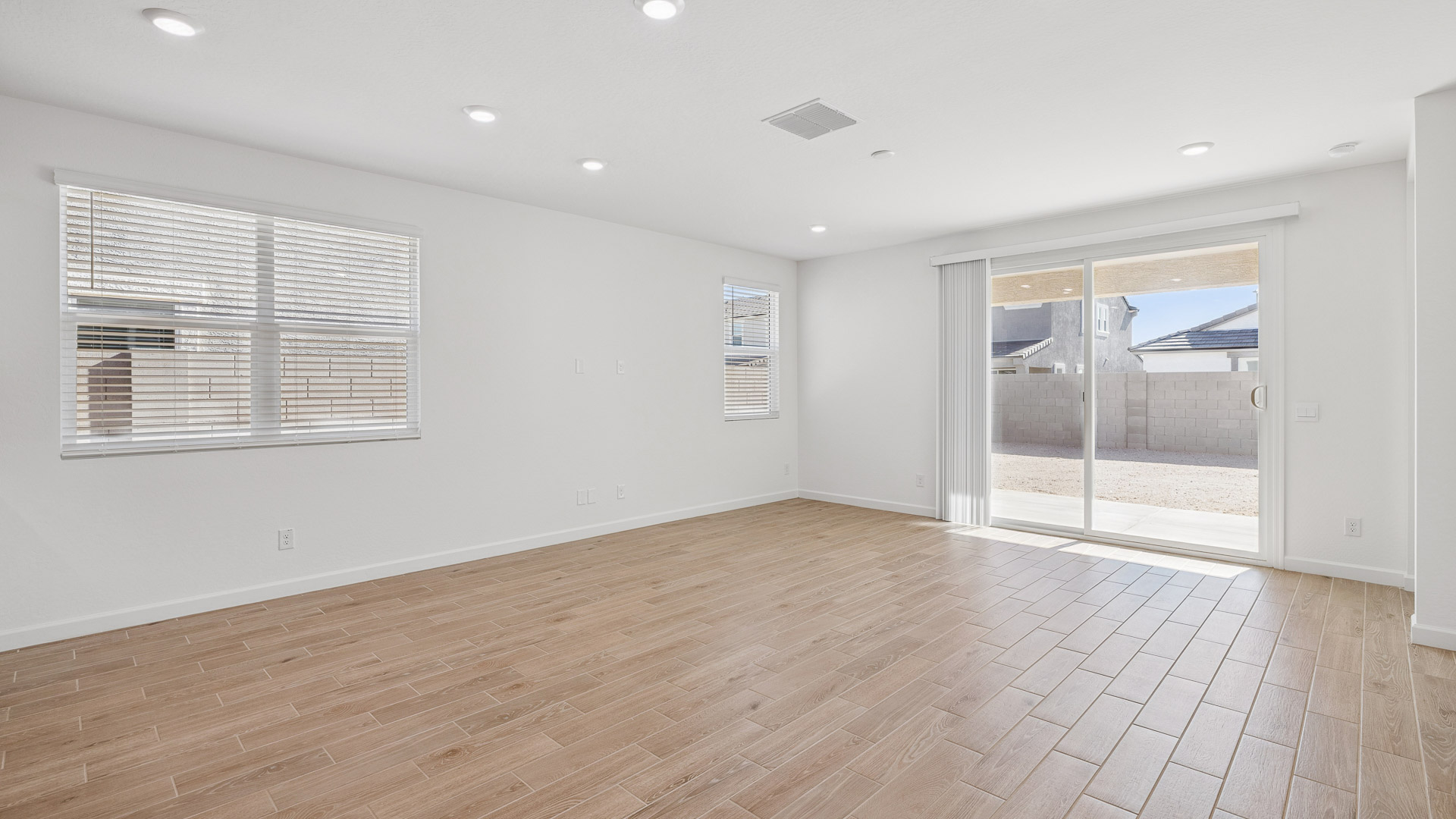 A well-organized living room that includes a kitchen and dining area, creating a warm and welcoming environment for gatherings.
