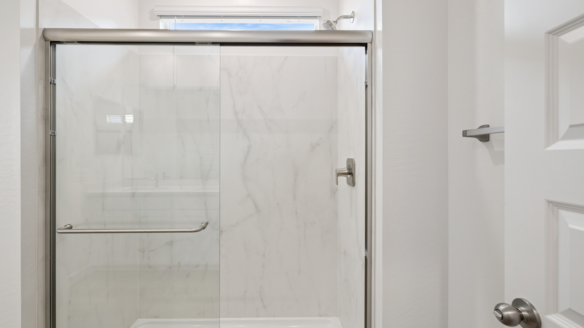 Primary bathroom with dual vanities.
