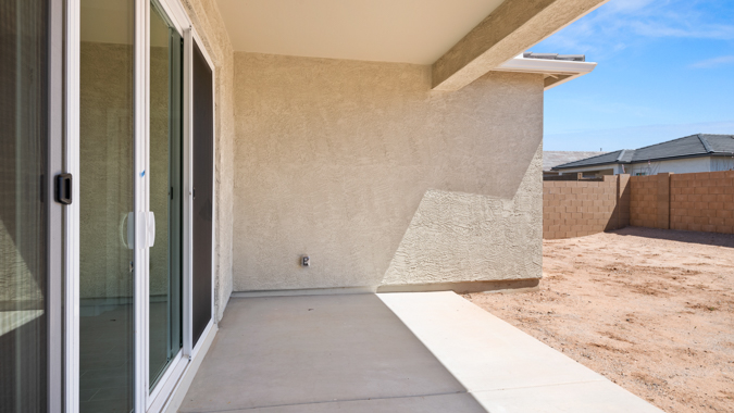 Large fenced-in backyard with a covered patio, perfect for outdoor entertaining.